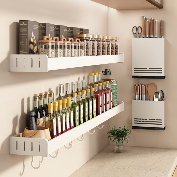Organized kitchen cabinet with a hanging spice rack and pull-out organizer